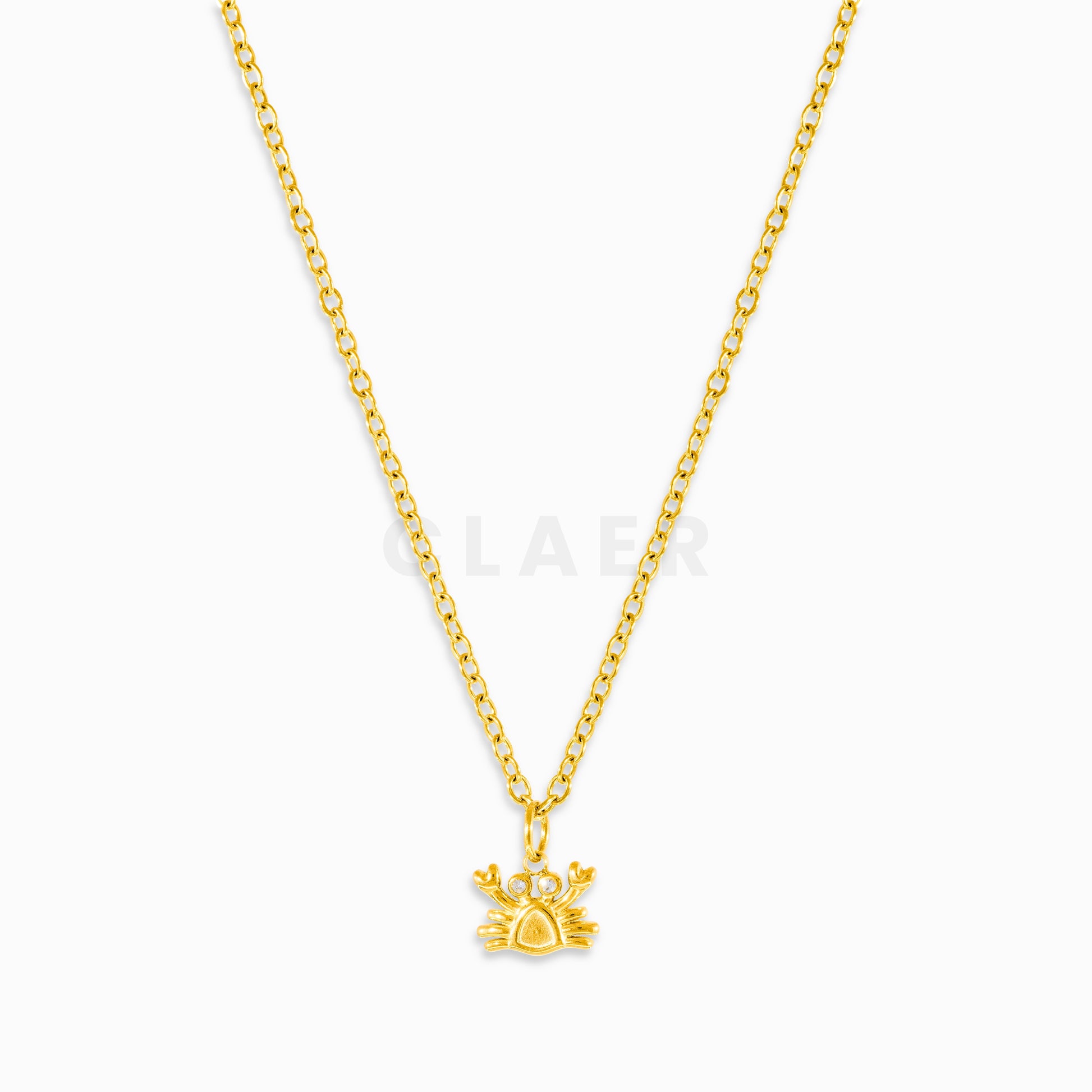 Goldene Gliederkette mit Anhänger in Krebsform. Die Augen aus Diamanten.
